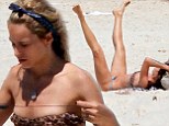 So that's her secret! Brazilian model Alice Dellal mixes work with pleasure as she exercises at the beach while in a tiny bikini