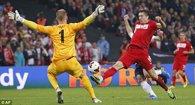 Hart stopper: England's goalkeeper makes a crucial save from Robert Lewandowski 