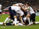 Smells like team spirit: Rooney is mobbed by his England team-mates after scoring in the World Cup qualifier 