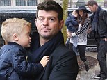 In the Thicke of it! Robin Thicke and family are caught in the rain as they tour the Catacombs of Paris
