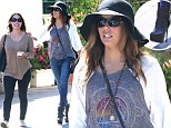 She gets by with a little help from her friends! Eva Longoria steadies herself with pal's shoulder as she teeters along in killer platform boots