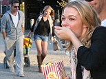She's got a healthy appetite! LeAnn Rimes scoffs buttery popcorn as she shows off her curvier figure in tiny shorts at the pumpkin patch with Eddie Cibrian 