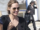 Angelina Jolie pulls off wide-brimmed hat as the rest of her clothes hang off her while the mystery ring remains on her wedding finger