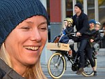 The more the merrier: Naomi Watts, Liev Schreiber, their sons Sam, far right, and Sasha, far left, all fit onto a three-seated bicycle as they headed to school in New York City on Wednesday