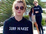 'Cleaning up and moving out!' Ireland Baldwin wears 'Surf Naked' hoodie to move into an apartment ahead of 18th birthday