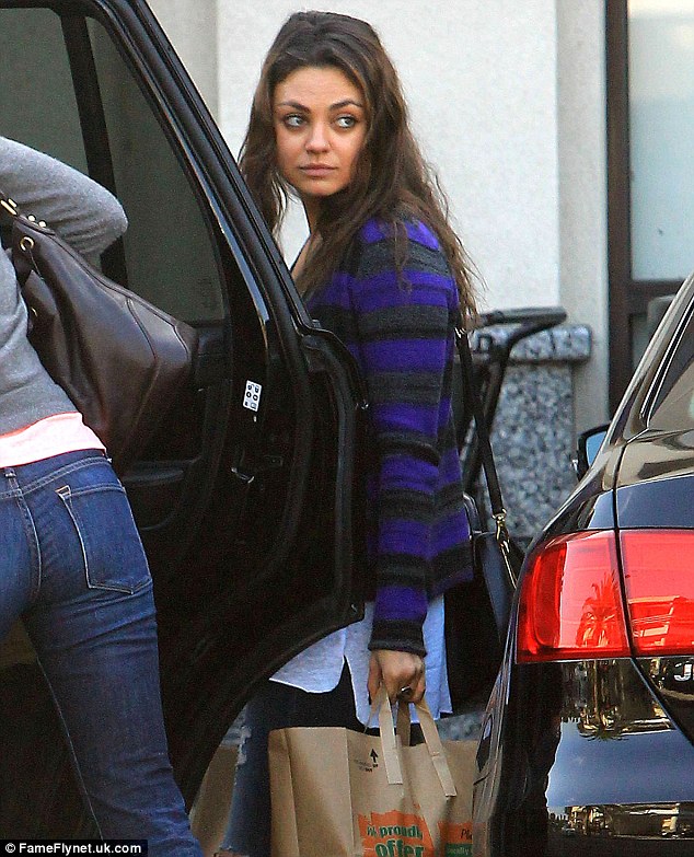 Bag lady: Mila Kunis did not mind carrying her own shopping after a trip to a shop in Los Angeles on Wednesday