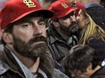 Bearded Jon Hamm silently cheers on the St Louis Cardinals at the World Series after undergoing surgery on his vocal chords 