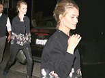 Coming up Rosie's! Ms Huntington-Whiteley does oversized chic in floral jumper and skintight leather trousers