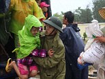 Operation: A Vietnamese soldier carries a young girl from a lorry as villagers are evacuated to a safe place by the military