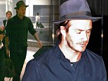 It's a hat trick! David Beckham cuts a dapper figure in matching dark blue trilby and shirt as he jets into Miami 