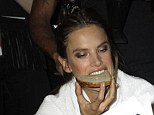 Runway fuel! Alessandra Ambrosio snacks on bread backstage as she prepares to take to the Victoria's Secret catwalk