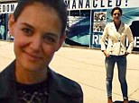 Sweet revenge? Katie Holmes stands in front of sign that reads 'Freedom' in South Africa as the veil over ex-husband Tom Cruise's peculiar personal life is lifted