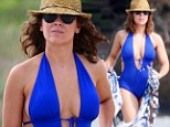 She's 40!? Alyssa Milano revealed her great shape in a plunging swimsuit as she took a romantic stroll with her husband David Bugliari on the beach in Hawaii on Sunday