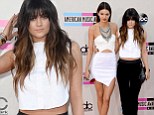 Bang on trend! Kylie Jenner debuts new fringe at American Music Awards while elder sister Kendall raises hemlines in a daring white mini dress 