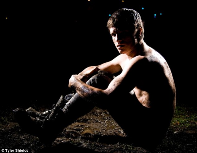 Getting dirty! The Hunger Games star posed shirtless in the mud for a shoot with photographer Tyler Shields