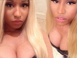 Showing off the kittens! Nicki Minaj's cleavage gets in the way as she shares snap of her new Hello Kitty slippers