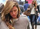 She's just getting warmed up! Make-up free Gisele Bundchen flicks her hair as she struts into photo shoot wearing skinny jeans and leather knee-high boots 