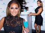 Adrienne Bailon stuns in black lace on a blue carpet as the former Cheetah Girl promotes her new cocktail recipe