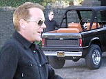 It's Thanksgiving NOT Christmas! Kiefer Sutherland looks pleased as he treats himself to a classic Ford SUV