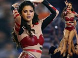 Thankful for those muscles? Selena Gomez is held high in the air by buff cheerleaders as she performs at Dallas Cowboys Thanksgiving game in red hot pants