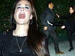 Screaming good time! Kyle Richards gets into a playful tussle with husband Mauricio while out to dinner