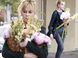 Blooming lovely! A makeup-free Melanie Griffith uses copious amounts of flowers to add colour to a grey old day