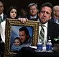 Portrait of grief: Neil Heslin, father of six-year-old Sandy Hook Elementary School shooting victim Jesse Lewis, holds a picture of him with Jesse as he testifies during a hearing before the Senate Judiciary Committee on 'The Assault Weapons Ban of 2013'