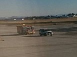 On the ground: Emergency personnel with the Tacoma Fire Department race to the plane to try to save the boy's life
