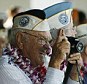 He made it!: Pearl Harbor survivor Ewalt Schatz takes a picture as the USS Halsey gets ready to pass the Arizona Memorial during the 72nd anniversary of the attack on Pearl Harbor at the WW II Valor in the Pacific National Monument