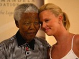 Tender: South African Oscar winner Charlize Theron shares a moment with Nelson Mandela on March 11, 2004, in Johannesburg, South Africa