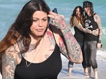 Smitten by the sea! Steven Tyler's heavily tattooed daughter Mia cuddles up to her boyfriend as they frolic on Miami Beach 