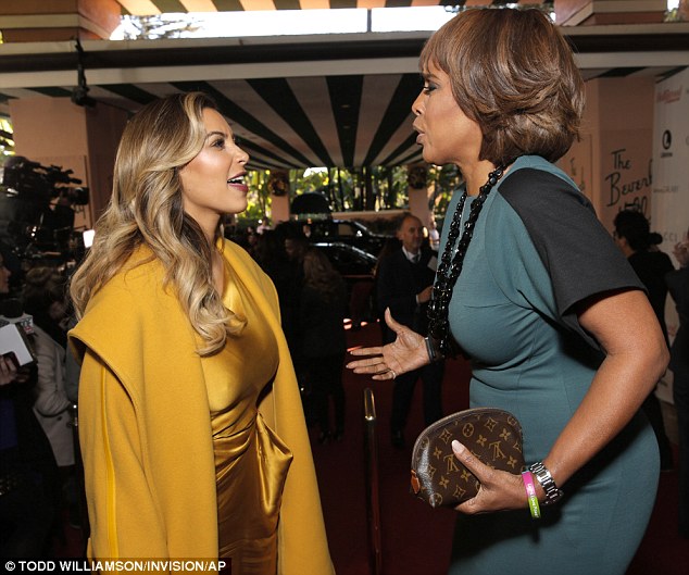 Don't forget Gayle! Outside of the hotel, Kim chatted to Oprah's best gal pal Gayle King 