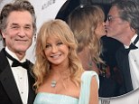 Still so in love after 30 years! Goldie Hawn steals a kiss from partner Kurt Russell as she is honoured at amfAR gala