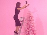Careful: Victoria Beckham decorates a pink Christmas tree with a Posh Spice figurine