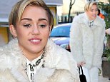 Talk about a complete 180! Miley Cyrus covers up in angelic head-to-toe white in New York following scantily-clad Bad Santa performance