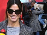 Mommy's here: Sandra Bullock appeared bright and chipper as she picked her son up from school on Wednesday in Los Angeles - wearing a gray tweed coat and jeans