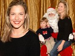 What's on your wish list? Ali Larter gets the giggles on Santa's lap as she attends children's charity event with her family