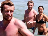 Simon Baker and his bikini-clad wife cool off with a dip in the ocean as they soak up the sun at Bondi Beach