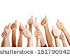 Many people congratulate a winner and holding their thumbs up - stock photo