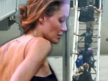 All aboard! Angelina Jolie displays her slender arms as she herds her six children onto a plane at Sydney Airport