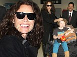 Growing up so fast! Minnie Driver was seen petting her boy Henry as he sat atop a mound of luggage at Los Angeles International Airport on Monday