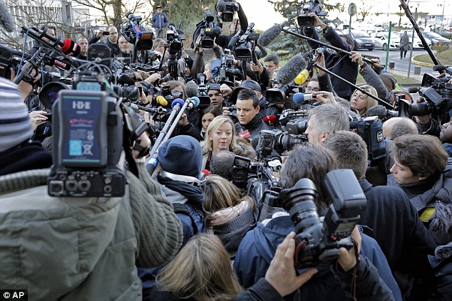 Desperate for updates: The media scrum around Schumacher's manager Sabine Khem gives an indication of the worldwide interest in the Formula One legend's recovery