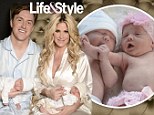 Kim Zolciak introduces newborn twins Kaia and Kane in heartwarming family snap... as she and husband Kroy Biermann pose in satin sleepwear 