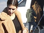 Whizzing back home: The Kardashian clan stand surrounded by luggage before boarding private jet in Utah