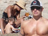 The star was looking buff as he went shirtless on the golden sand during a family outing.