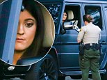 Kylie looked glum as an officer wrote out a ticket after stopping her vehicle in Malibu, California