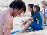 So ARE they dating? Pictures emerge of Charlize Theron and Sean Penn watching the sunset on Hawaii break... as she heads to the gym back home