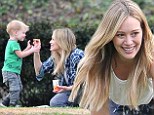 Say cheese! Hilary Duff feeds her little boy cheddar Goldfish crackers during playful romp in the park