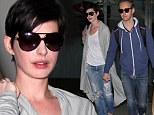 Up, up and Hath-away! Anne jets out of LA in ripped jeans and baggy cardie with husband Adam in tow