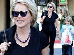 Like mother, like son! Sharon Stone and son Roan sport similar blonde crops as they shop for toys